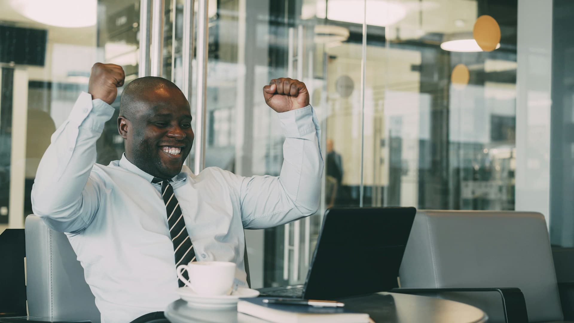A business owner celebrating as funds settle into the account.