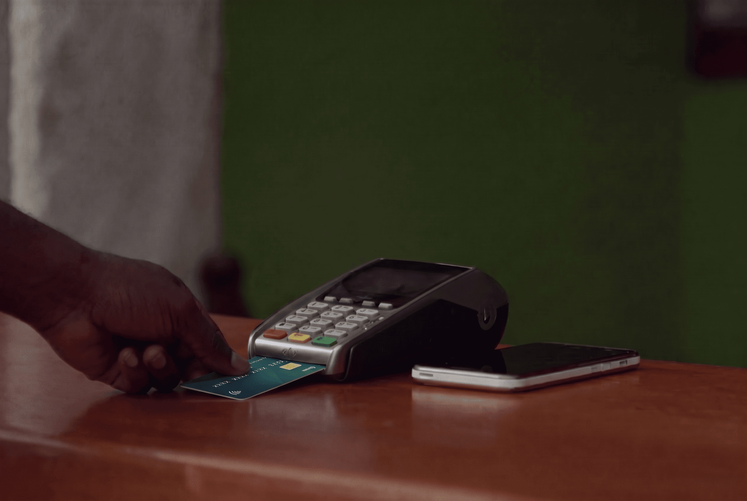A customer inserting a debit card into a payment terminal.